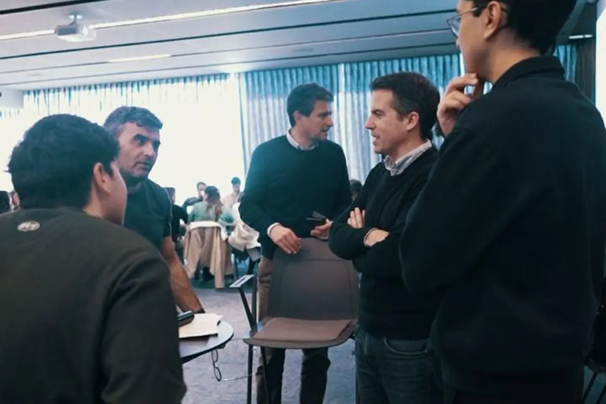 Participantes de una capacitación de Aithor conversando de pie al terminar el encuentro